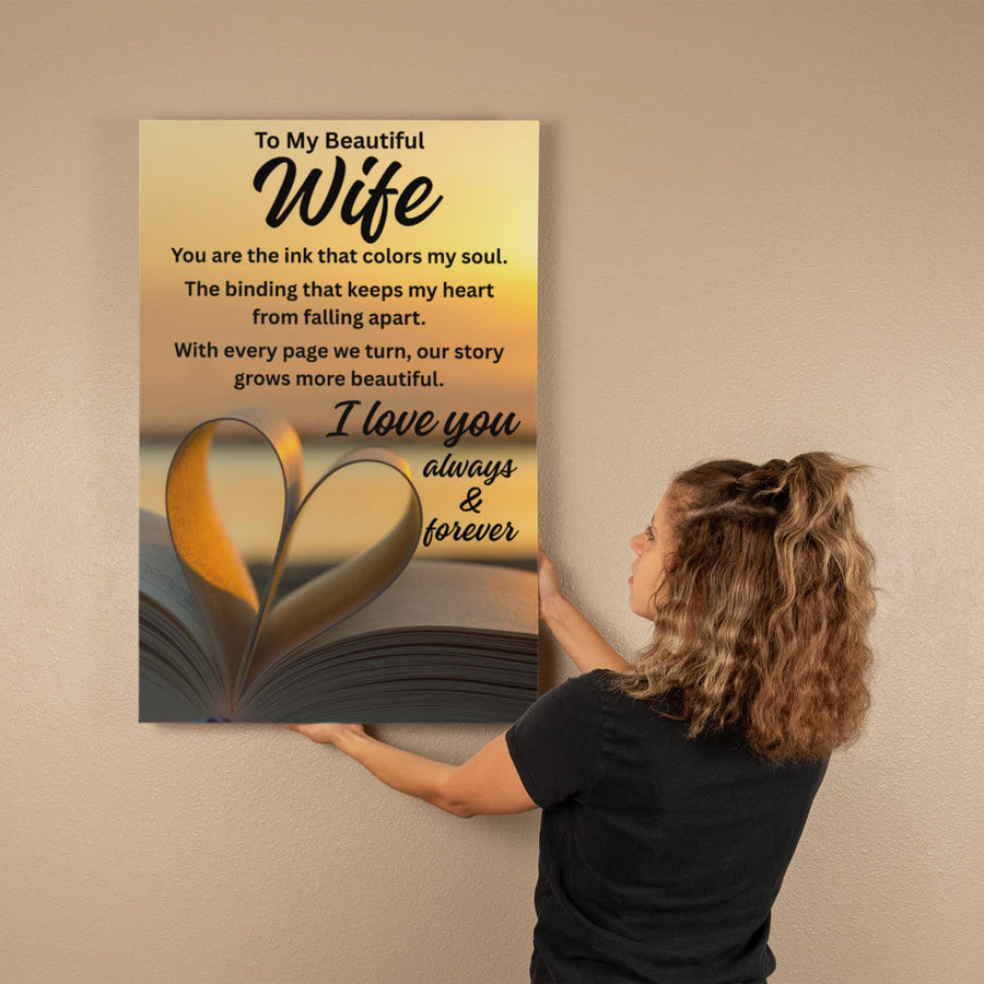 woman putting a gallery wrapped canvas on the wall