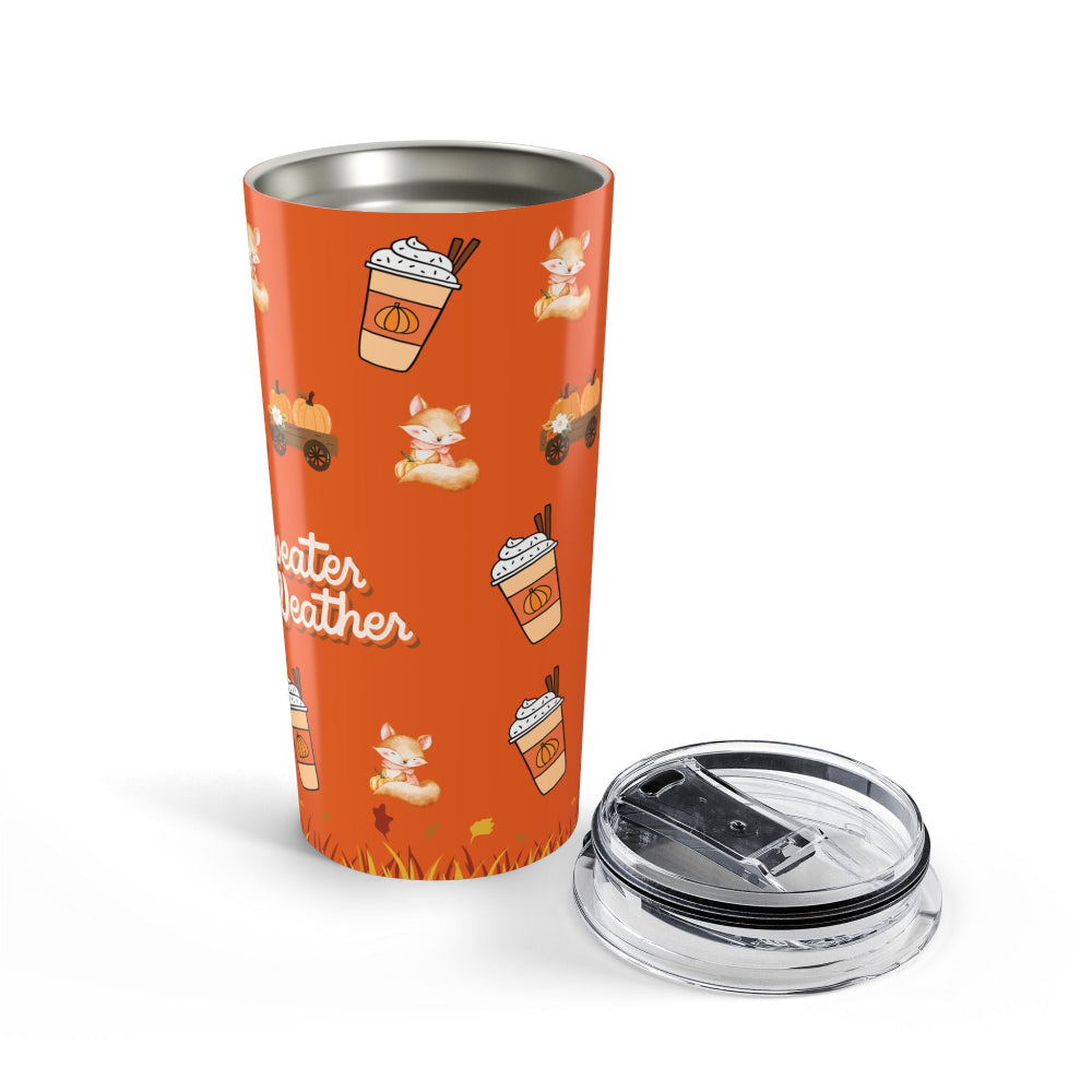 Orange tumbler with autumn-themed design and clear lid on a white background
