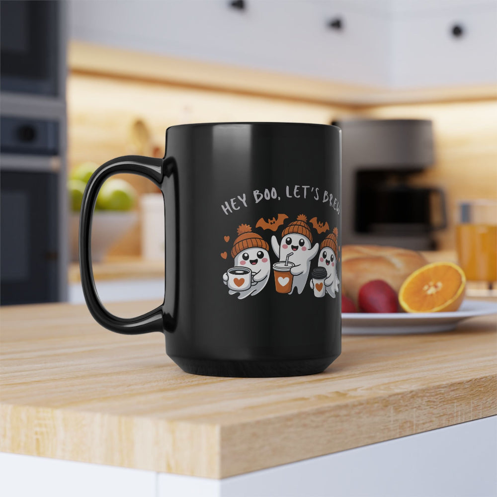 Black mug with Halloween-themed design on a kitchen counter