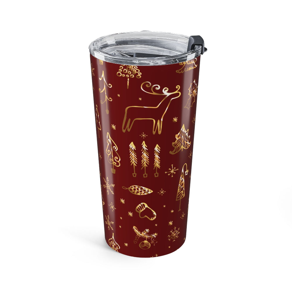 Red tumbler with gold Christmas-themed designs on a white background