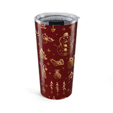 Red tumbler with gold Christmas-themed designs on a white background