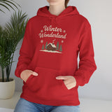 Person wearing a red hoodie with 'Winter Wonderland' design, standing indoors next to a plant.