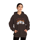 Person wearing a brown hoodie with ghost design and text on a white background