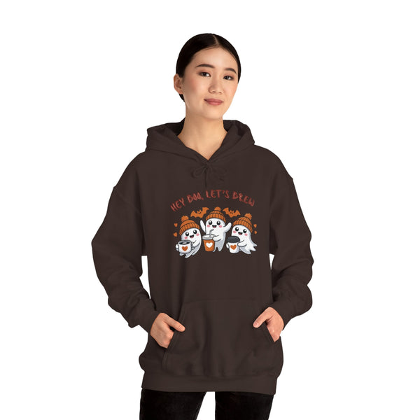 Person wearing a brown hoodie with ghost design and text on a white background
