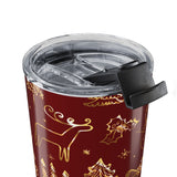 Red tumbler with gold reindeer and tree pattern on a white background