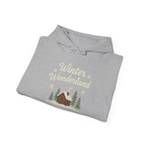 Folded gray hoodie with 'Winter Wonderland' text and cabin graphic on a white background