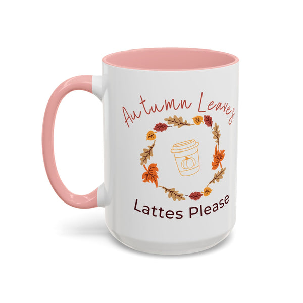 White mug with pink interior and handle, featuring autumn-themed text and graphics.