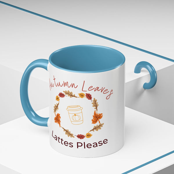 Mug with blue interior and handle, featuring autumn-themed design and text.