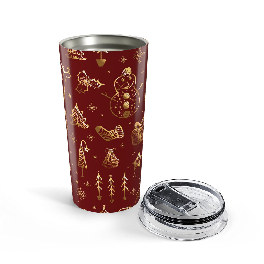 Red tumbler with gold Christmas-themed designs on a white background