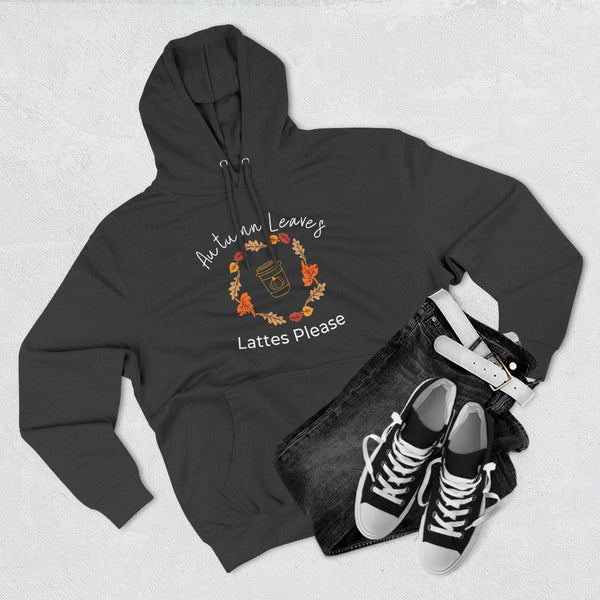 Black hoodie with autumn-themed design, black jeans, and black sneakers on a light gray background