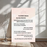 A vertical printed card with a sweet 'To Child's Name' poem titled 'My Little PRINCESS' stands against a sunlit wall. The card has a very pale blush pink background with black text and a small crown illustration at the top.