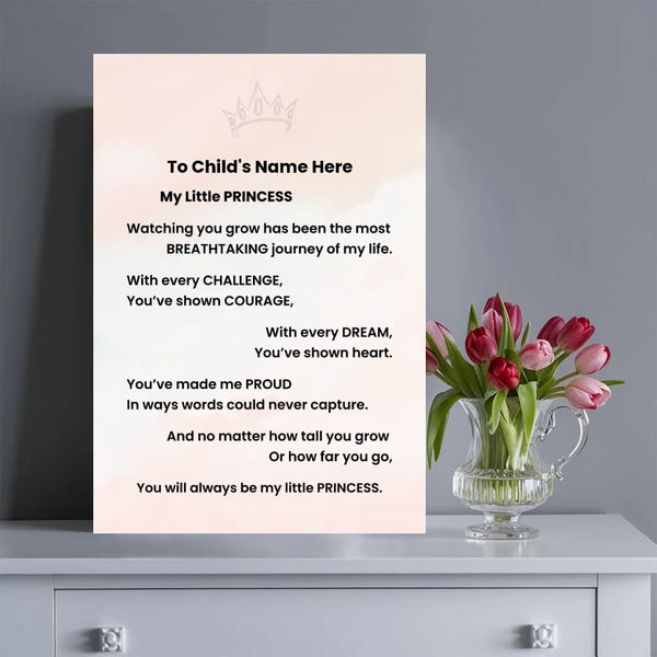 A personalized children's memorial or farewell poster displayed on a light gray cabinet next to a glass vase of pink tulips. The poster features a soft pink background with a small crown illustration at the top and a customizable text template that reads 'To Child's Name Here My Little PRINCESS [poem]'.