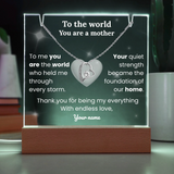 Decorative plaque with a heart-shaped necklace and personalized text on a dark background.