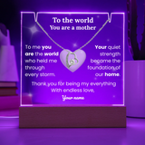 Necklace with heart pendant on a purple stand with engraved message