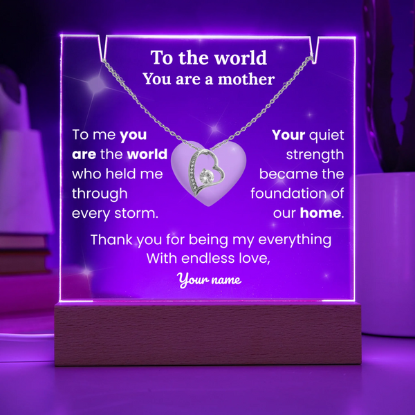 Necklace with heart pendant on a purple stand with engraved message