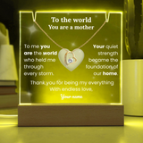 Necklace with heart pendant on a glowing stand with sentimental text