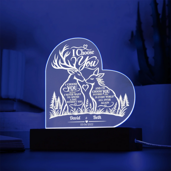 A heart-shaped acrylic LED night light on a black base, featuring a deer and fox design with personalized text 'I Choose You' and names 'David & Beth' with the date '05.05.