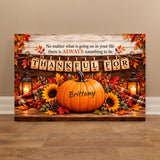 A rectangular autumn-themed wall art print leaning against a beige wall on a wood floor. The design shows a large orange pumpkin with the name Brittany, sunflowers, fall leaves, lanterns, and a banner reading THANK YOU FOR, with a quote above.