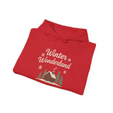 Folded red hoodie with 'Winter Wonderland' text and cabin graphic on a white background