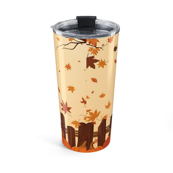 Tumbler with autumn leaf design on a beige background