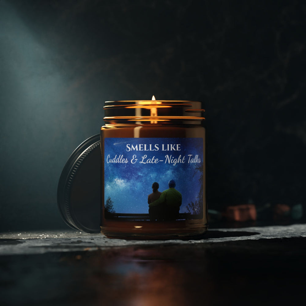 Candle in a jar with a label featuring two people sitting under a starry sky, set against a dark background.