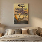 Canvas print with romantic message and heart design above a bed in a bedroom.