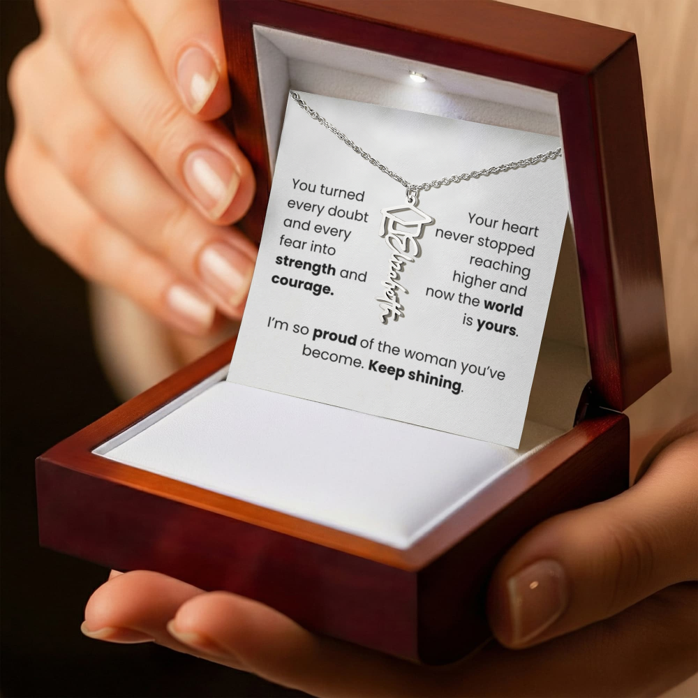 Necklace in a wooden box with a message card held by hands