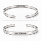 Two polished silver-tone open cuff bracelets shown on a white background, each with the text 'Your Text Here' engraved on the inside.