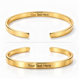Two polished gold open cuff bracelets shown on a white background, one above the other, each with the engraved placeholder text 'Your Text Here' on the inside.
