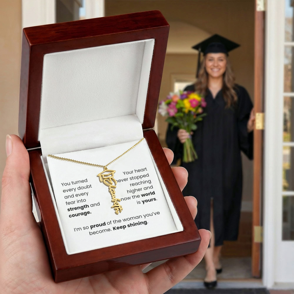Yellow Gold Graduation-themed necklace in a wooden box with a graduate in the background.