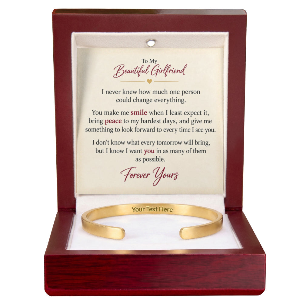 A gold open cuff bracelet presented in a dark reddish-brown wooden gift box with a white insert card that reads 'To My Beautiful Girlfriend' and includes a placeholder line 'Your Text Here'.