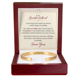 A gold open cuff bracelet presented in a dark reddish-brown wooden gift box with a white insert card that reads 'To My Beautiful Girlfriend' and includes a placeholder line 'Your Text Here'.