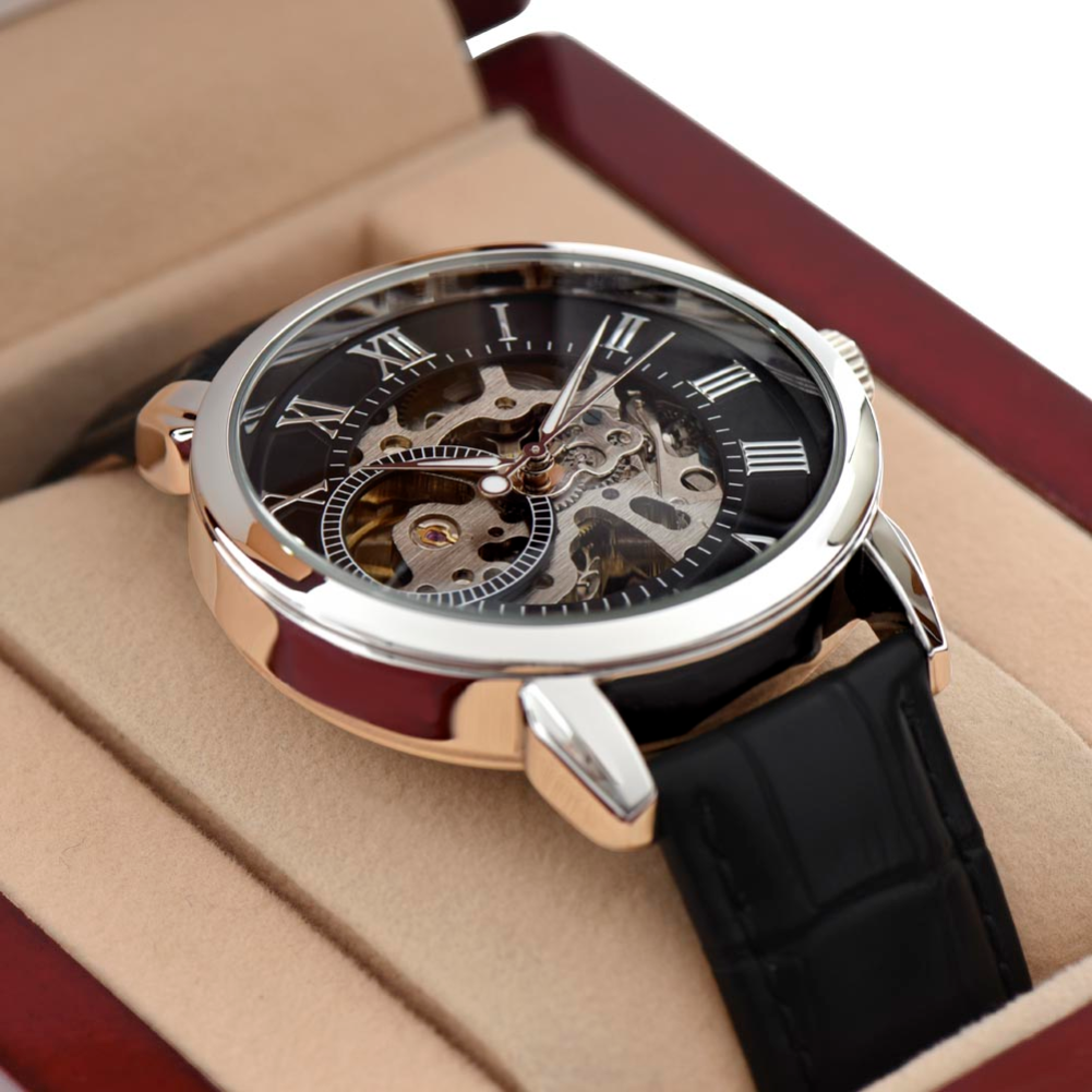 Mechanical watch with black strap and visible gears on a beige cushion