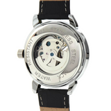 Rear view of an automatic skeleton watch showing its transparent case back, mechanical movement, and black leather strap.