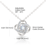 Silver necklace with adjustable cable chain and cubic zirconia pendant on a white background