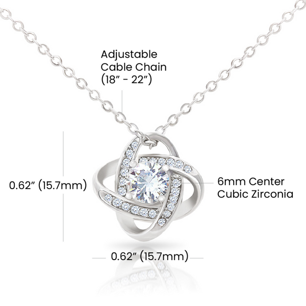 Silver necklace with adjustable cable chain and cubic zirconia pendant on a white background