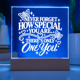 Meaningful acrylic keepsake for daughter glowing blue on wooden LED base