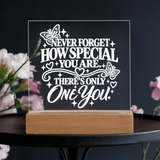 One of a Kind keepsake for daughter displayed on wooden base with floral background