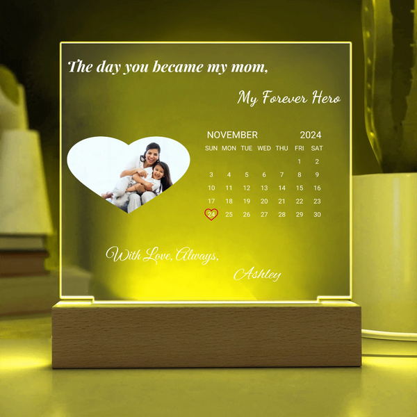 Personalized calendar with a photo of a family on a wooden stand, glowing green.