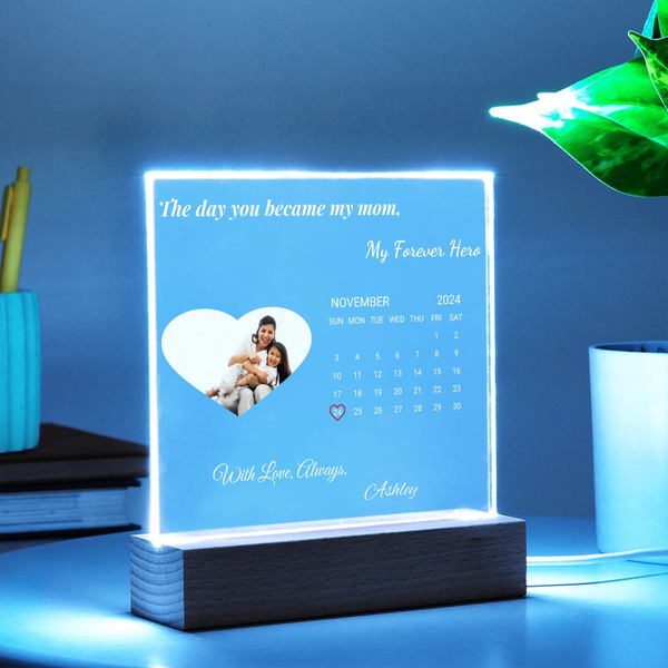 Personalized light-up display with a heart-shaped photo of a family and text on a blue background.