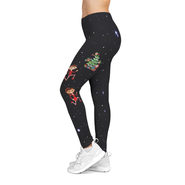 Black leggings with Christmas-themed graphics worn by a person on a white background