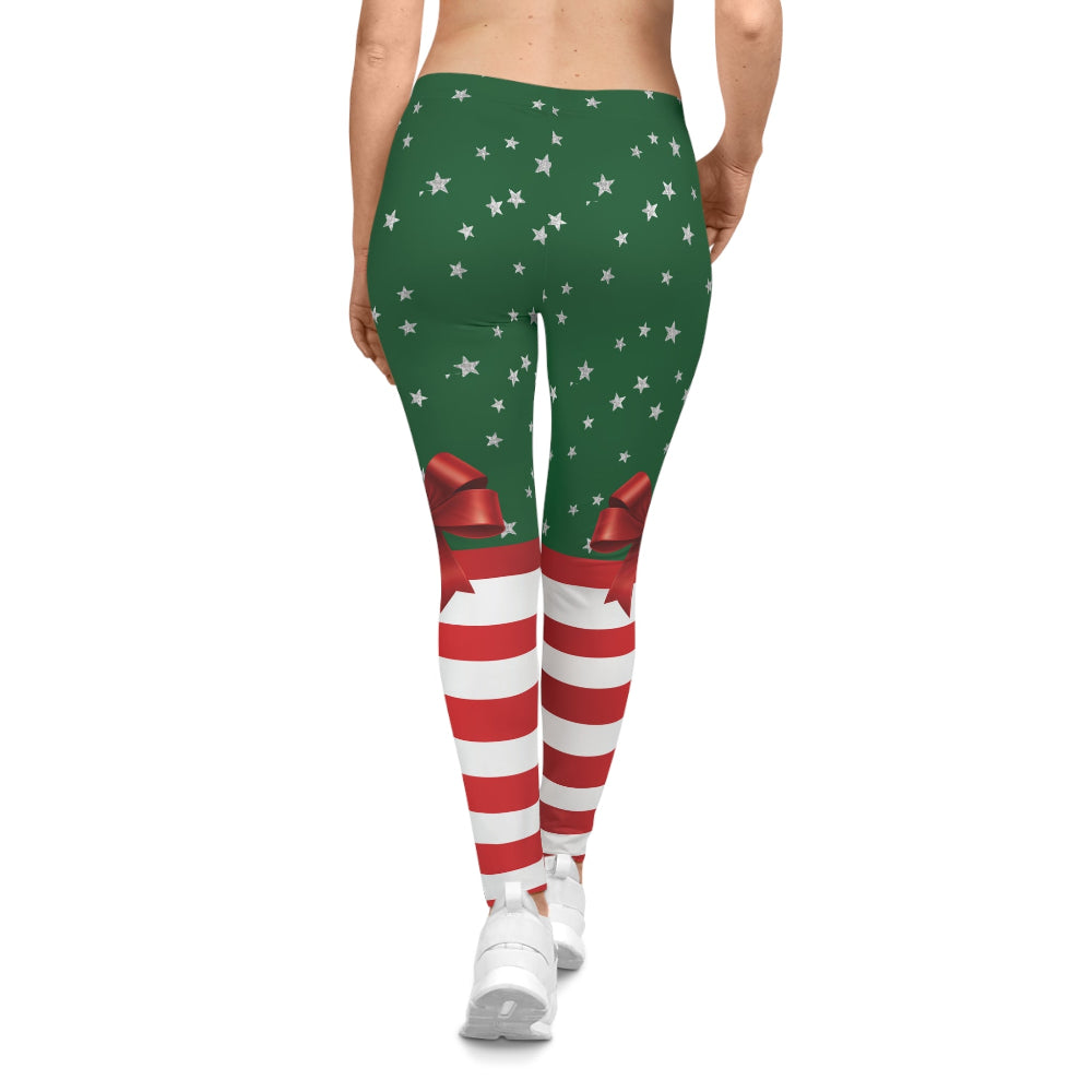 Green leggings with red and white pattern worn by a person on a white background