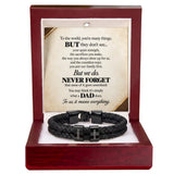 A black braided cord bracelet with silver-toned metal clasps engraved with the names 'DAVID' and 'IAN', presented inside an open reddish-brown wooden gift box with a printed memorial message card.