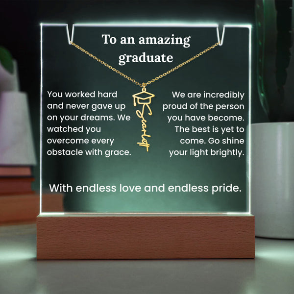 Decorative plaque with a gold necklace and engraved text, placed on a stand.