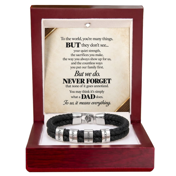 A black braided cord bracelet with silver-toned engraved beads and a clasp, presented inside an open dark red wooden gift box. The box contains a cream-colored message card with a poem dedicated to Dad.