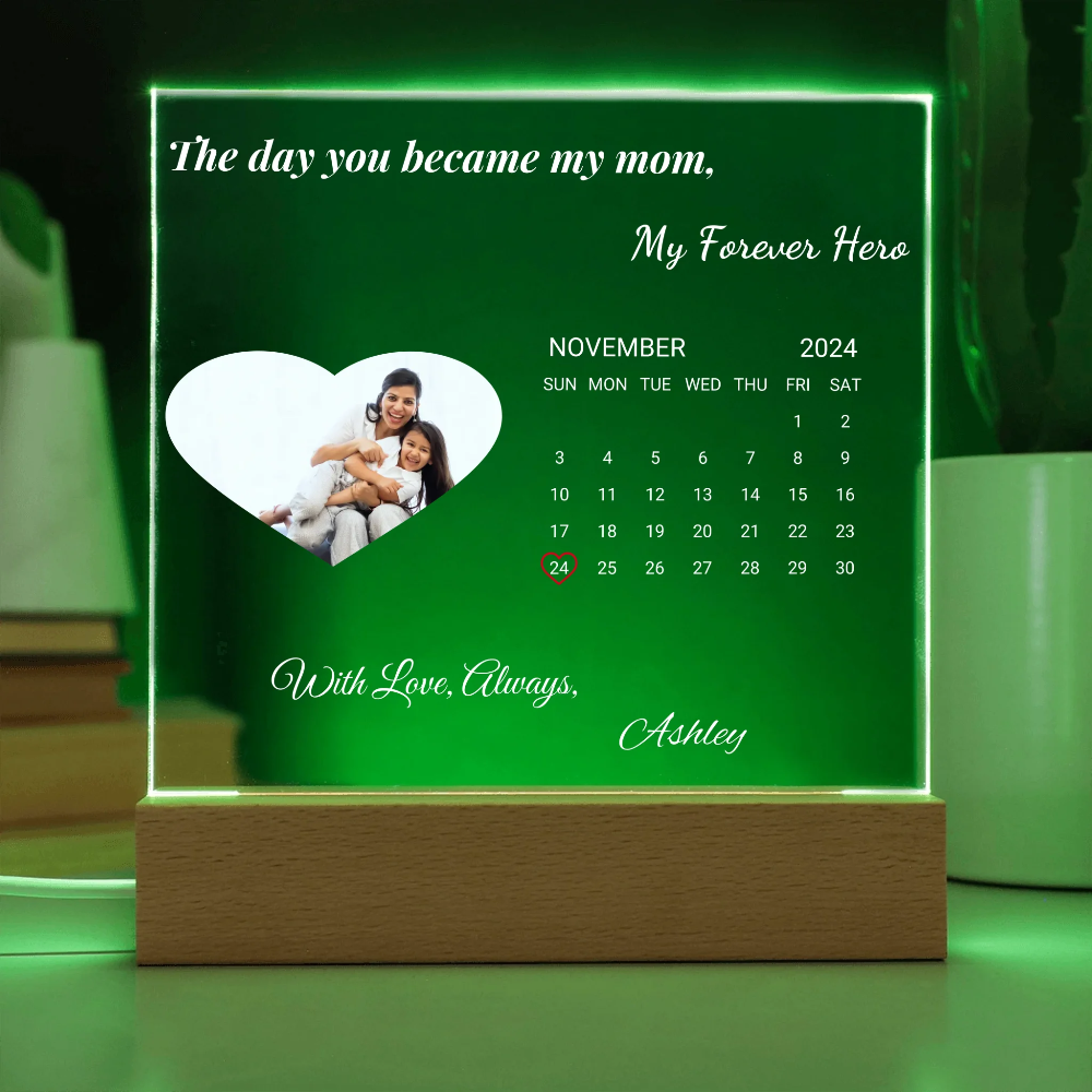 Personalized calendar with a photo of a woman and child, text 'The day you became my mom, My Forever Hero' on a green background.