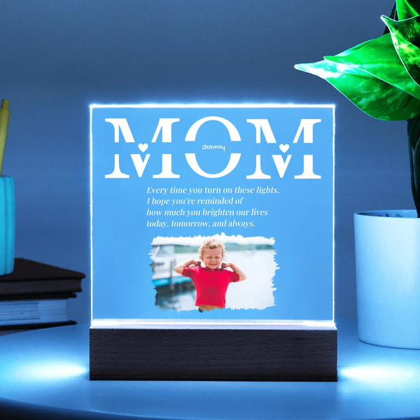 LED sign with 'MOM' text and a photo of a child, on a blue background.