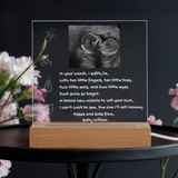 Decorative lamp with ultrasound photo and text on a dark background
