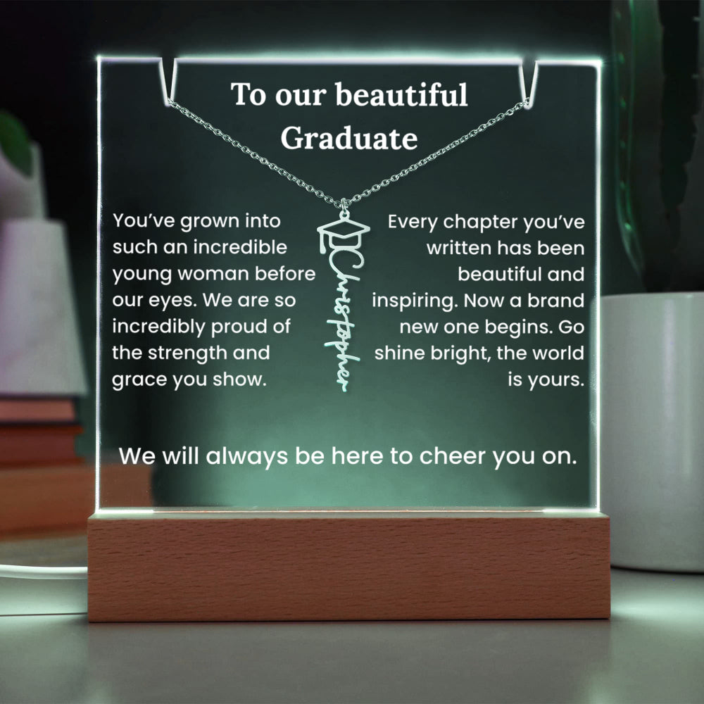 Decorative plaque with a necklace design and graduation message on a wooden base.