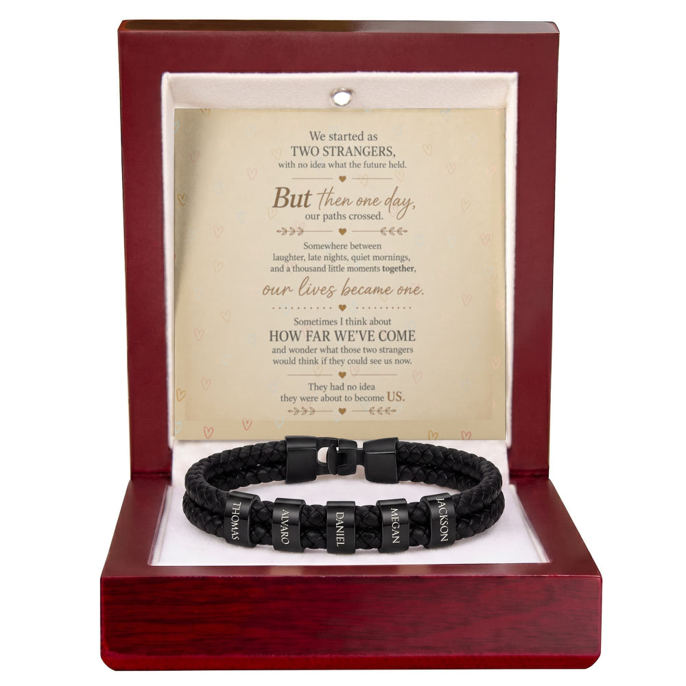 A black braided bracelet with engraved letter beads spelling 'LOVE' and 'FATE', presented inside a dark red wooden gift box with a white insert and a sentimental poem printed on the back.